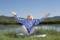 Elderly man sitting on a river bank Royalty Free Stock Photo