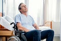 Elderly man sitting in wheelchair in chamber in hospital Royalty Free Stock Photo