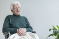 Elderly man sitting in a wheelchair and thinking about good times. Place your poster Royalty Free Stock Photo