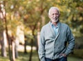 Elderly man smiling outdoors in nature Royalty Free Stock Photo