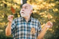 Elderly man smiling outdoors in nature. Portrait of a senior man outdoors walking in a park. Portrait of handsome old Royalty Free Stock Photo