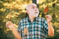 Elderly man smiling outdoors in nature. Portrait of a senior man outdoors walking in a park. Portrait of handsome old Royalty Free Stock Photo