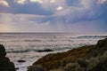 Elderly man stand up paddle boarding early morning at Forster Beach NSW Austraila