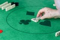 An elderly man starting a domino game