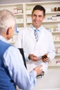 Elderly man talking with American pharmacist