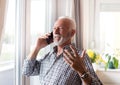 Elderly man talking on phone a home Royalty Free Stock Photo