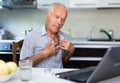 Elderly man talks on a video call, consulting using a laptop Royalty Free Stock Photo