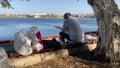 Elderly man tourist read newspaper in park back view. Enjoy vacation sunny day.