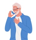 Elderly man uses an asthma inhaler against attack. World asthma day. Bronchial asthma. Allergy, asthmatic. Inhalation