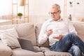 Elderly Man Using Laptop Computer And Having Coffee Royalty Free Stock Photo