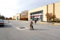 Elderly man with walker walks toward Kohl\'s + Sephora holiday entrance