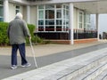 10/04/2020 Portsmouth, Hampshire, UK An elderly man walking with the aid of a walking stick Royalty Free Stock Photo