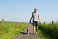 Elderly man walking the dog Royalty Free Stock Photo