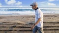 Elderly man walking in the Papuma beach Royalty Free Stock Photo