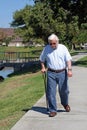 Elderly man walks with a cane Royalty Free Stock Photo