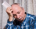 Elderly man wants to take a pill Royalty Free Stock Photo