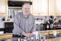 Elderly man washing dishes Royalty Free Stock Photo