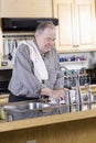 Elderly man washing dishes Royalty Free Stock Photo