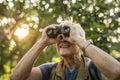 Elderly man watching birds with binoculars Royalty Free Stock Photo