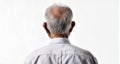 Elderly man in white shirt with receding hairline