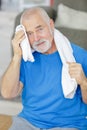 Elderly man wiping transpiration after working out