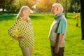 Elderly man and woman outdoors.