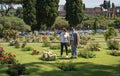 Elderly man and woman wearing masks wearing rose garden in Rome in second year of coronavirus epidemic covid-19, Italy
