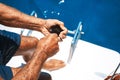 Elderly man on a yacht holding a sea urchin. Royalty Free Stock Photo