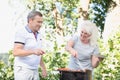 Elderly marriage grilling meat together.