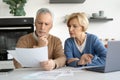 Elderly married couple looking at documents carefully Royalty Free Stock Photo