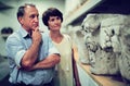 Married couple looking at exhibits in a historical museum