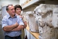 Elderly married couple looking at exhibits in a historical museum