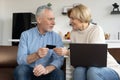 Elderly married couple paying online with credit card Royalty Free Stock Photo