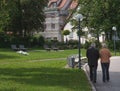 Elderly married couple walks in the park