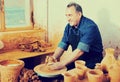 Elderly master among the pottery