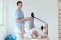 Man doing gymnastic exercises with a young female physiotherapist Royalty Free Stock Photo