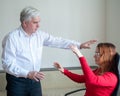 An elderly man hypnotizes a female patient. A woman in a session with a male hypnotherapist during a session. Therapist