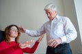 An elderly man hypnotizes a female patient. A woman in a session with a male hypnotherapist during a session. Therapist Royalty Free Stock Photo