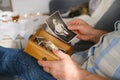 An elderly man looks through his old photographs of 1960-1965, the concept of nostalgia and memories of youth, childhood,