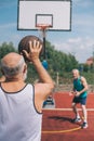 elderly men playing basketball together on playground Royalty Free Stock Photo