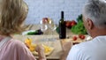 Elderly man and woman cooking traditional dinner together at home, family chores Royalty Free Stock Photo