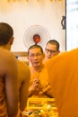 Elderly monk praying among others