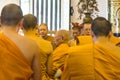 Elderly monk praying among others