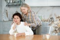 Elderly mother calms her daughter down and asks her for forgiveness after a domestic quarrel in kitchen