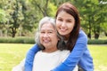 Elderly mother and daughter smiling happily in the park in the morning. Royalty Free Stock Photo
