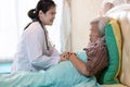 Elderly mother with depressive symptoms or alzheimer woman,feel sad,asian female doctor or daughter holding elderly patientÃ¢â¬â¢s Royalty Free Stock Photo