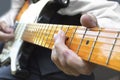 Elderly musician playing electric guitar.