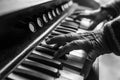 Elderly musician playing a piano indoors