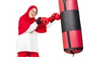 Elderly muslim woman punching a boxing sacks