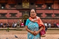 An elderly Nepali woman in front of a temple in Kathmandu